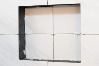 A niche with spacers and tile on the back.