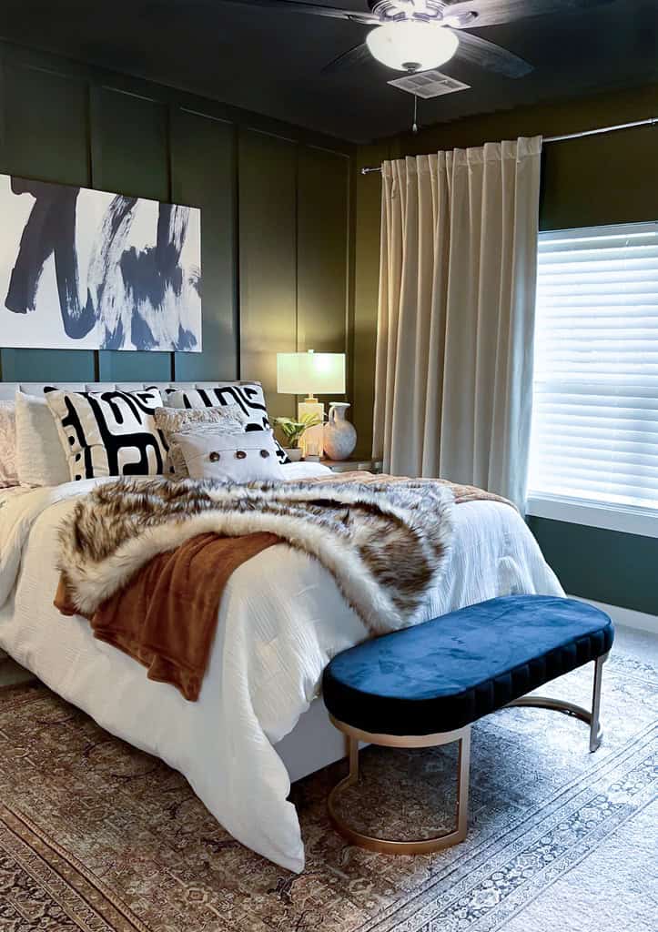 Bedroom with black walls and abstract painting in a textured bed.