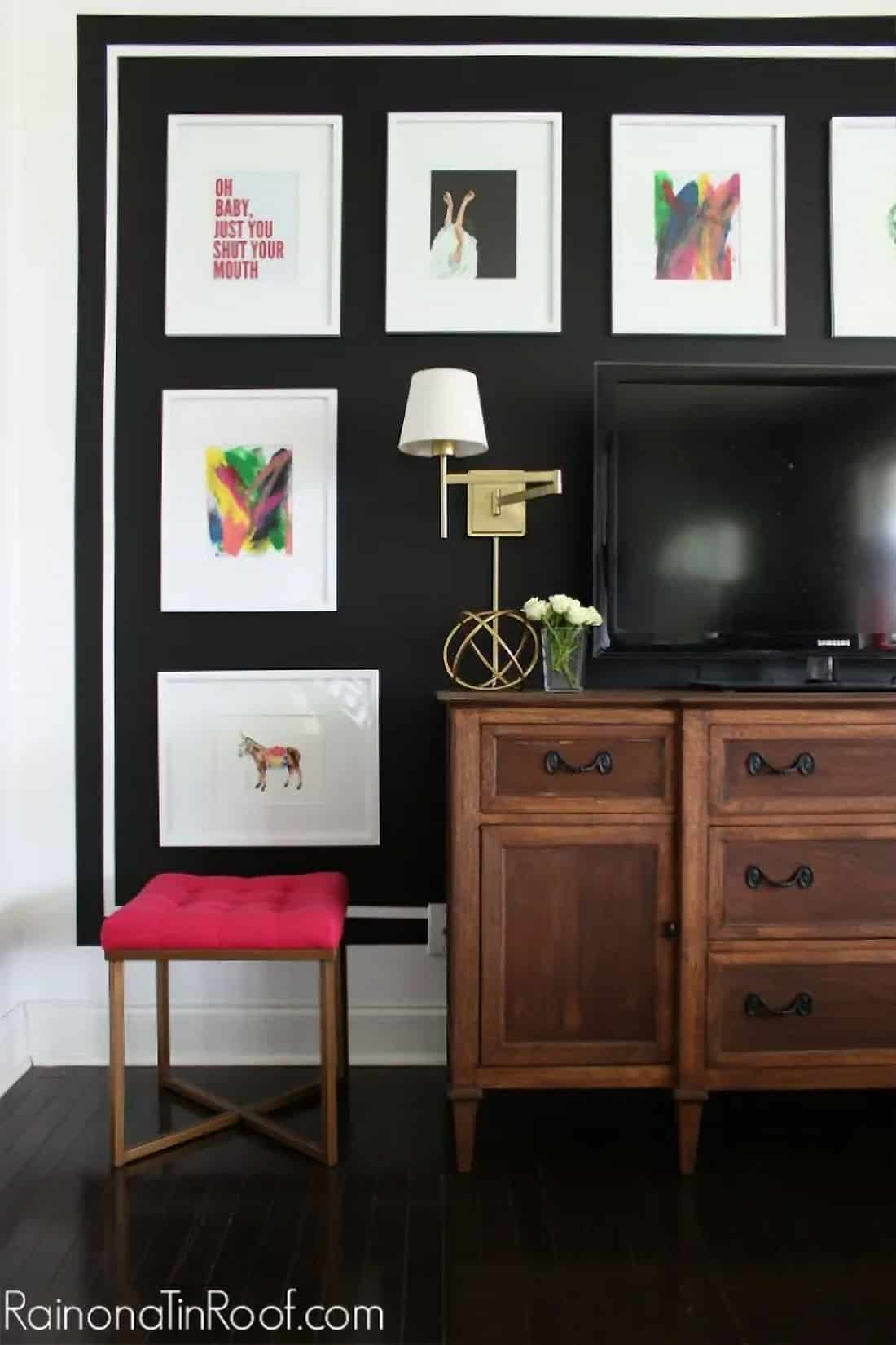 Living room gallery wall painted black with stripe accent.