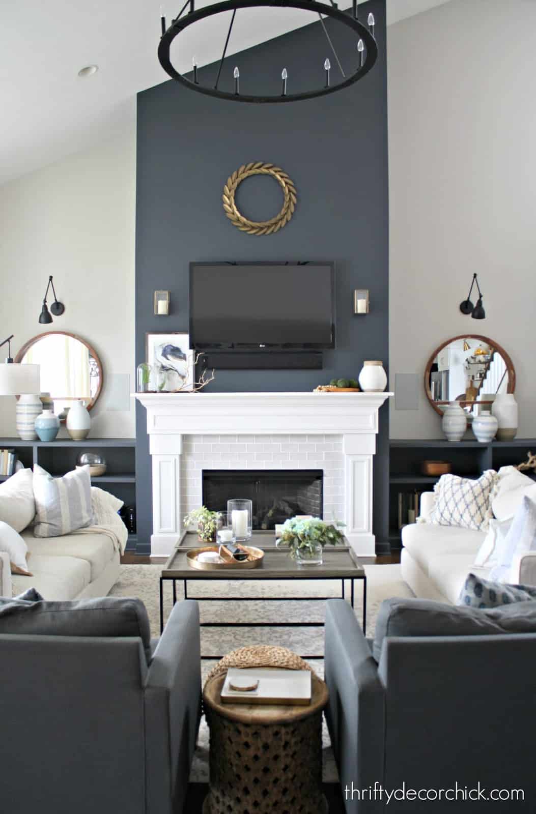 Black and white living room with grey painted fireplace feature wall.