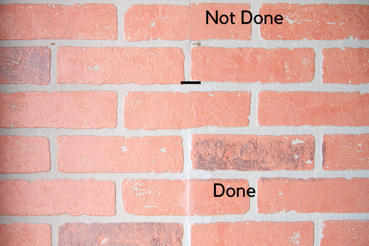 Before and after of touching up faux brick panels.