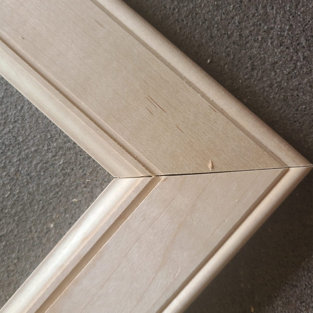 A closeup of the edge of doors to show the router detailing of traditional cabinet doors.