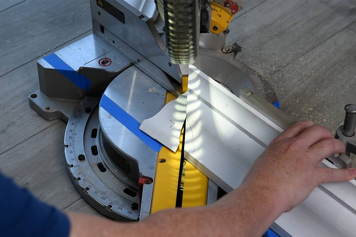 A piece of crown molding being cut.