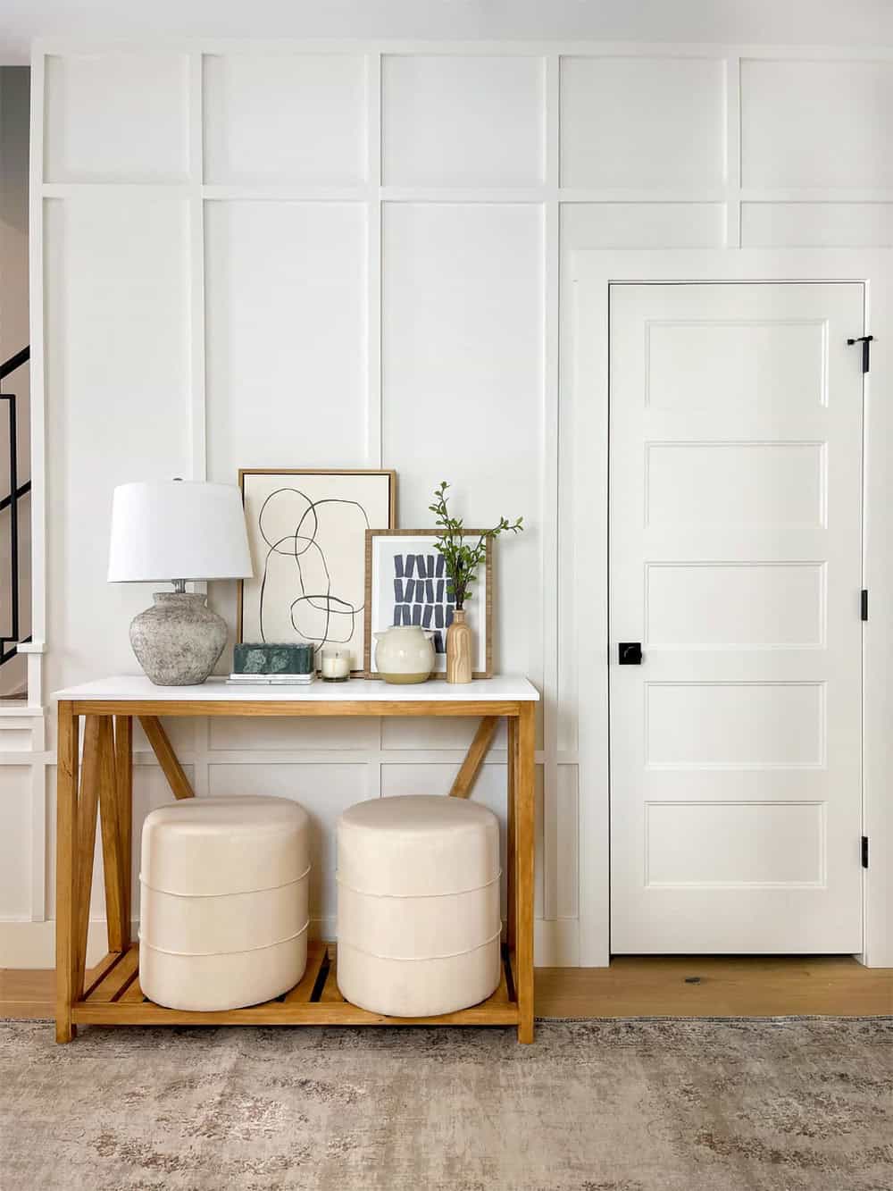 Paneled entryway design featuring Benjamin Moore Swiss Coffee.