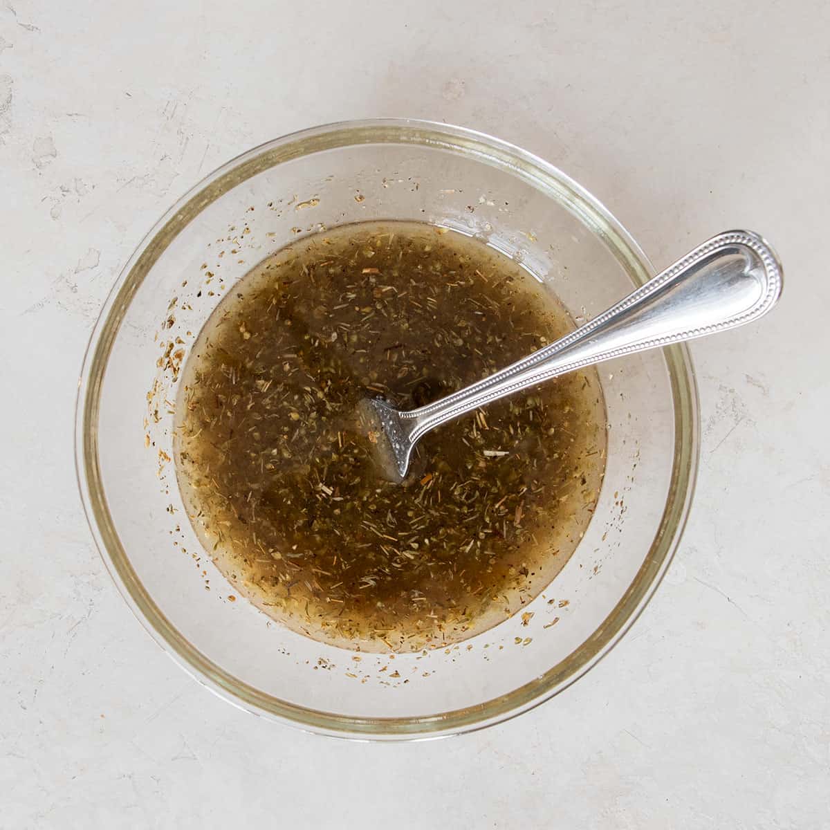 A bowl of homemade mediterranean marinade.
