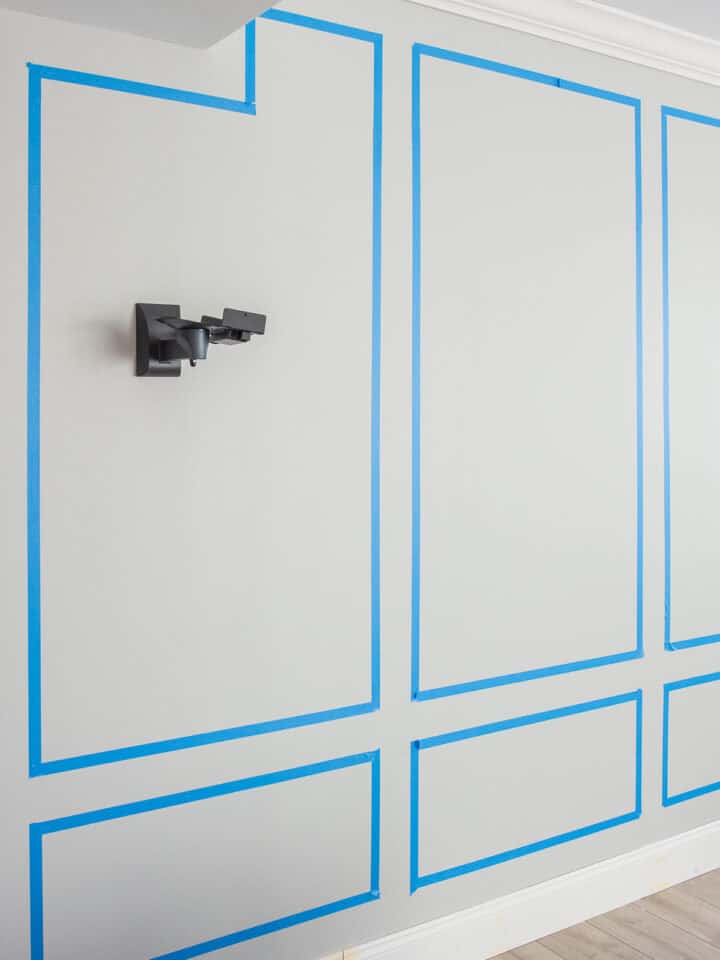 Wall with tape on it to show picture frame molding layout.
